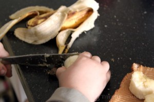 Getting involved in making their own food increases children's likelihood of eating well. --- Titus 2 Homemaker (toddler making a banana sandwich)